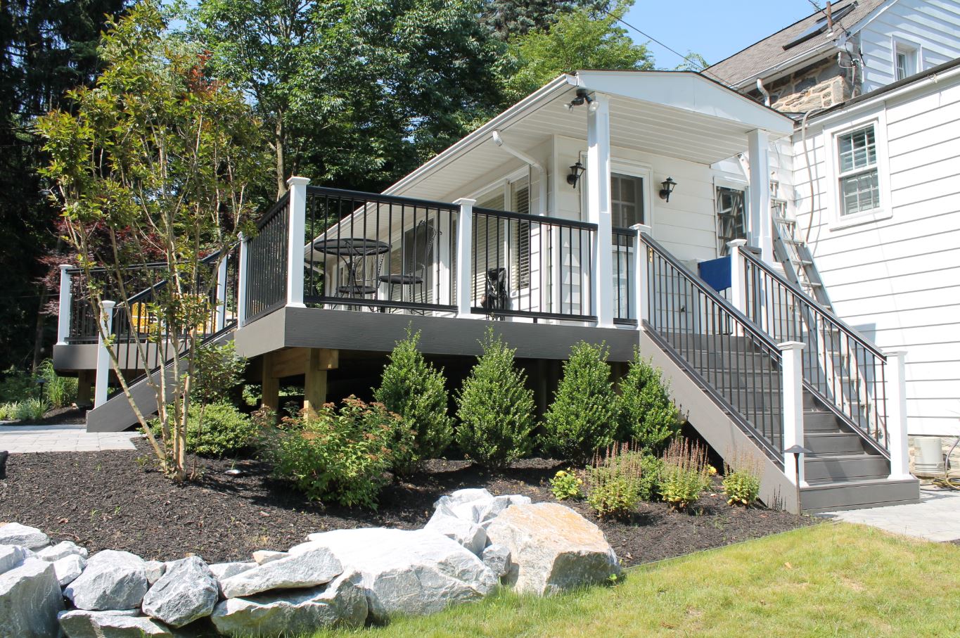 Backyard with deck and outdoor seating | outdoor living contractor clarksboro nj | Creative Pavers