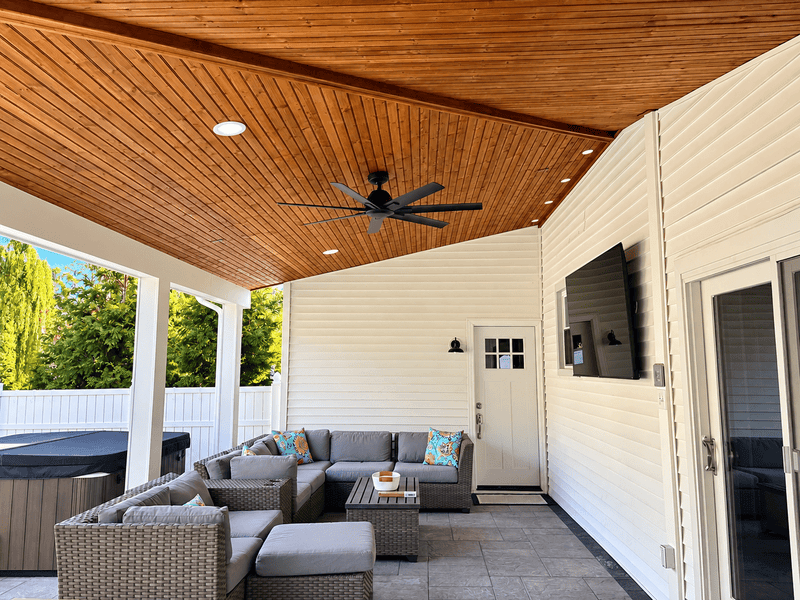 Patio seating with TV and hot tub | outdoor kitchen contractor Devon, PA | Creative Pavers, Inc.