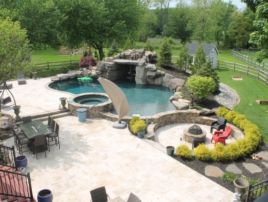 Fireplace underneath pergola | outdoor kitchen trends | Creative Pavers
